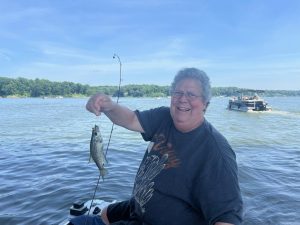Herman Bueno proudly holds up a fish he just caught. Fishing was one of his favorite hobbies.