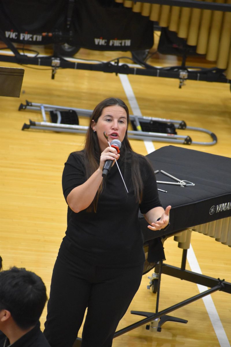 Southport Middle School band teacher Rejeana Kosch announces the beginning of the concert. She was given the microphone after principal David Walpole introduced the band directors and teachers.