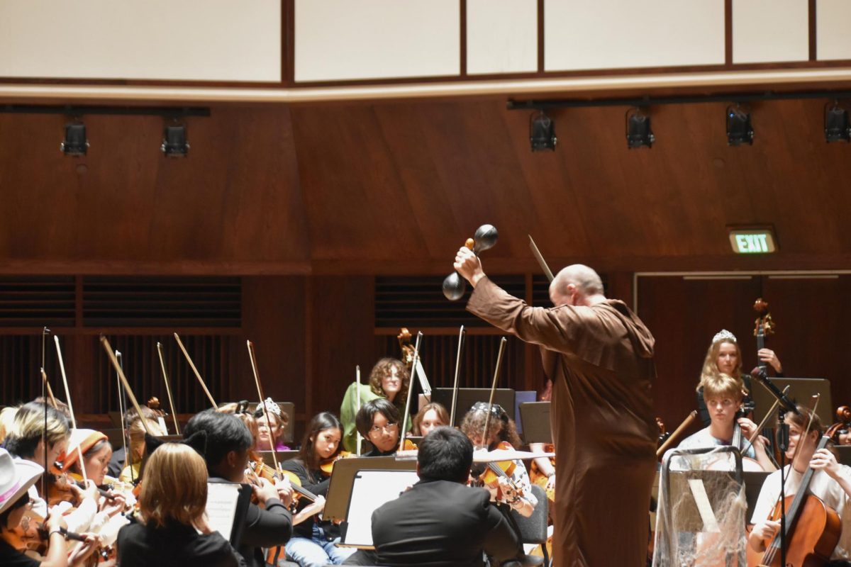 Orchestra teacher Thomas Wright conducts SHS's advanced orchestra during their performance of "insert song title." The orchestra performed ___ pieces, ranging from ____.