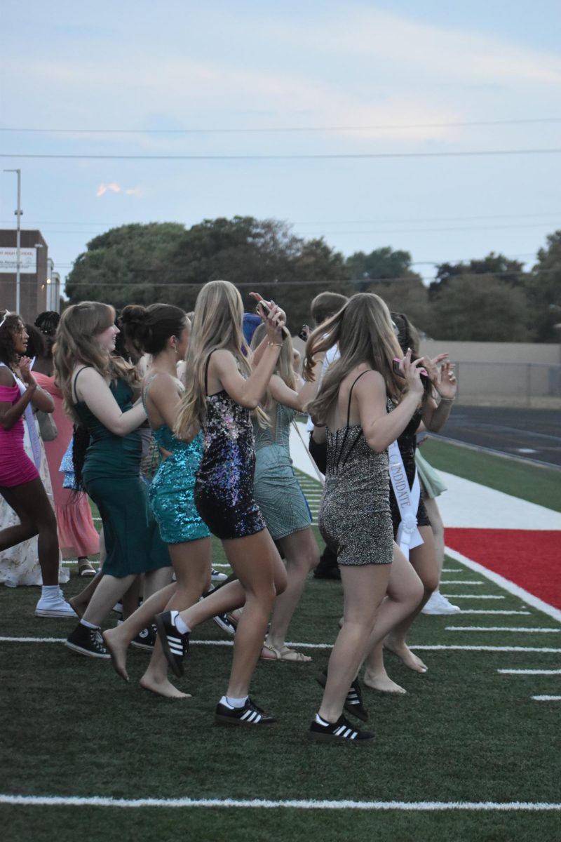 Students dance together in a group at the Homecoming dance. They danced to the song "Wobble."
