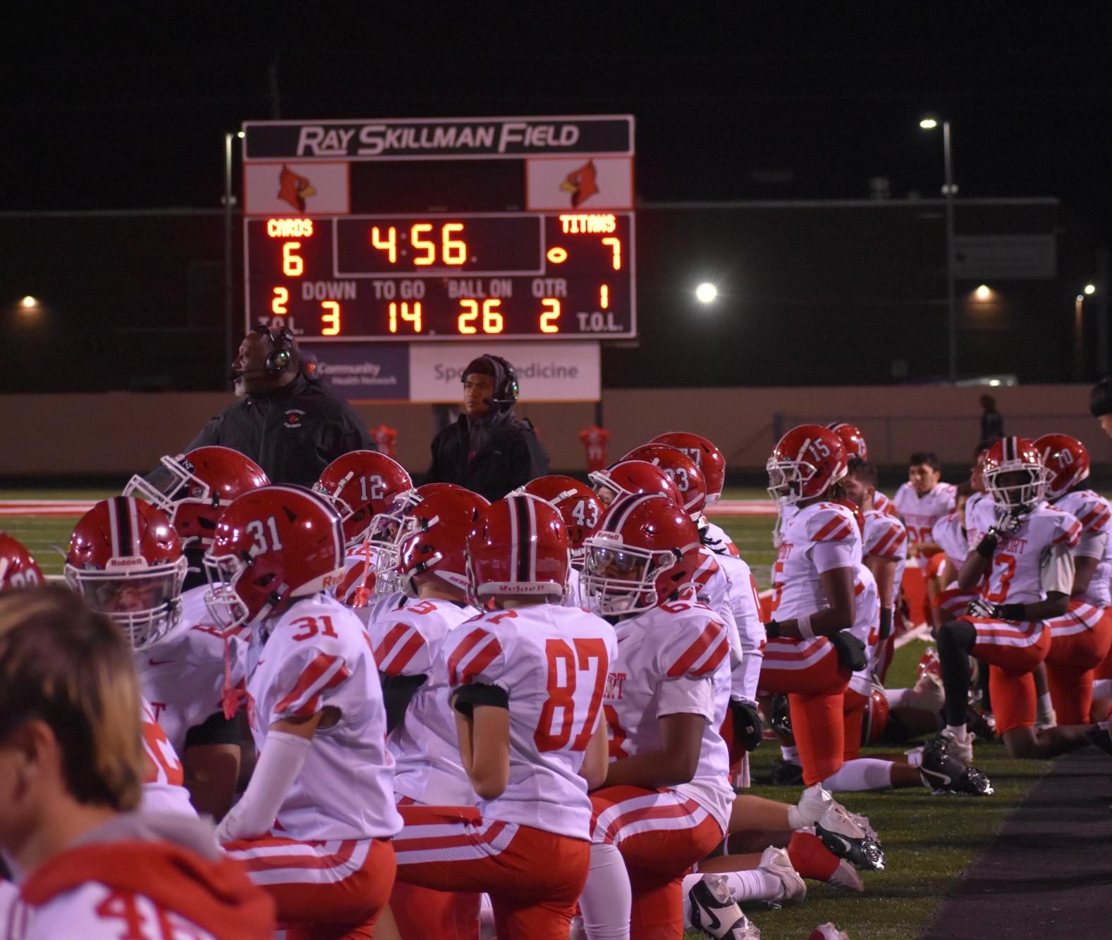 The Cards' sideline kneels as an injured Arsenal Tech player is being treated.
On Friday night, the Cards claimed victory over the Titans 22-7.