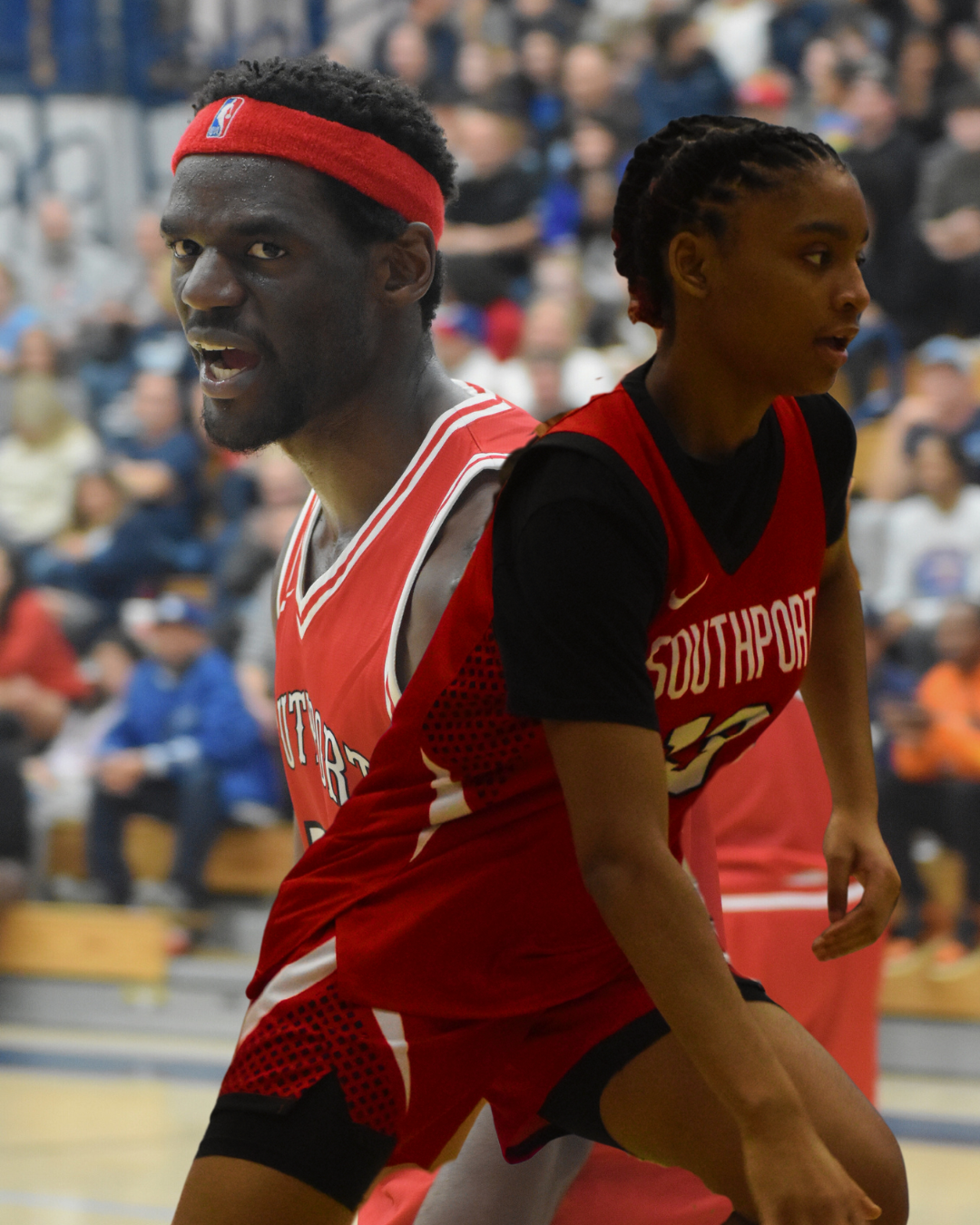 (background image. photo by Kennedy Coachran) Senior James Kalala yells in aggression towards the ref after a call. (front image. photo by Kiley Bowman) Sophomore Mariah Flanagan drives towards the basket seeking a foul. 