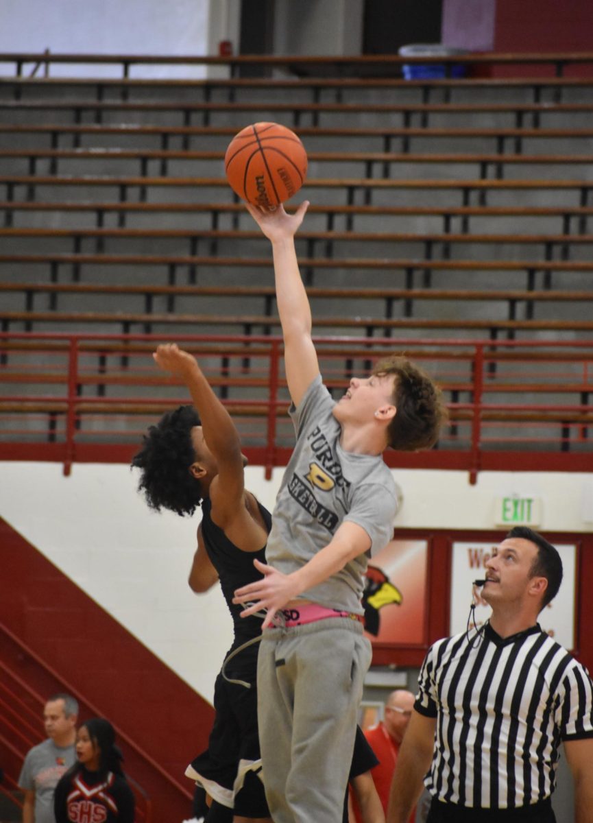 Duncan and junior Jackson Watson jump to win the tip off for their team. The juniors won the tip off.