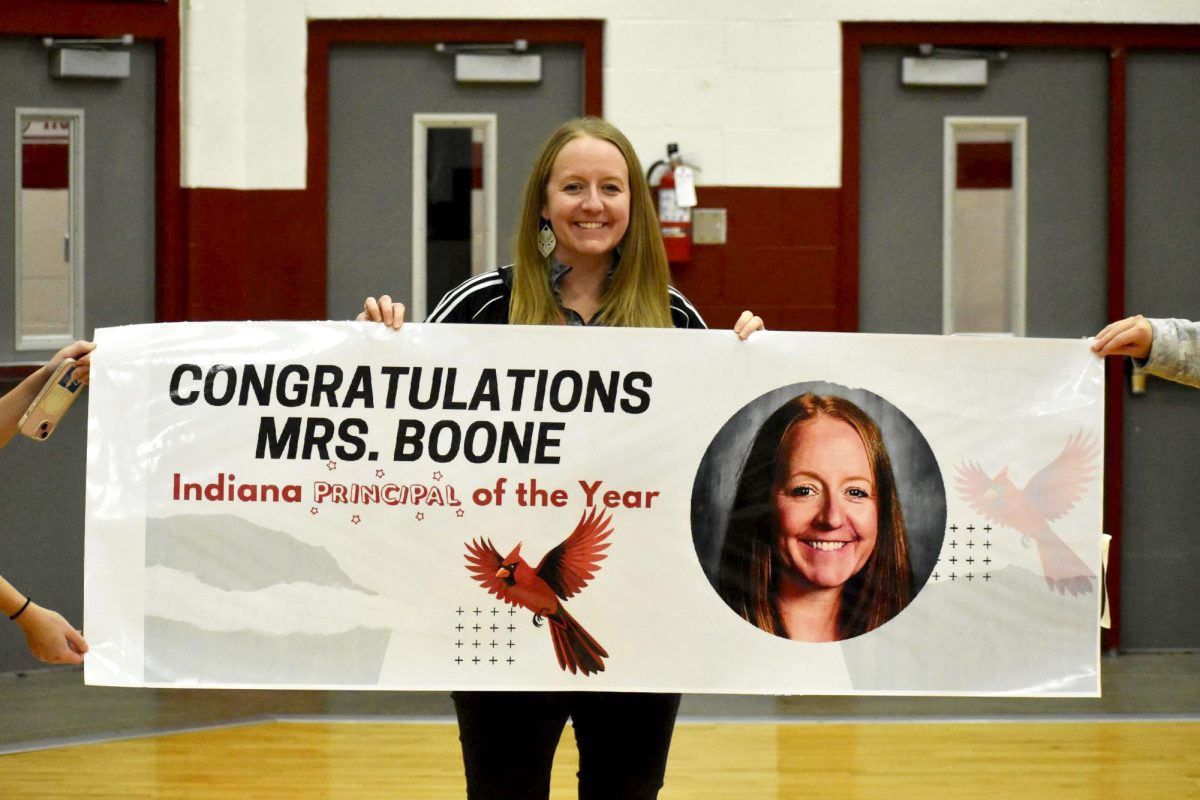 Amy Boone holds up Indiana Principal of the Year poster on Nov. 25. Boone was awarded the poster nearing the conclusion of the Pep Session.
