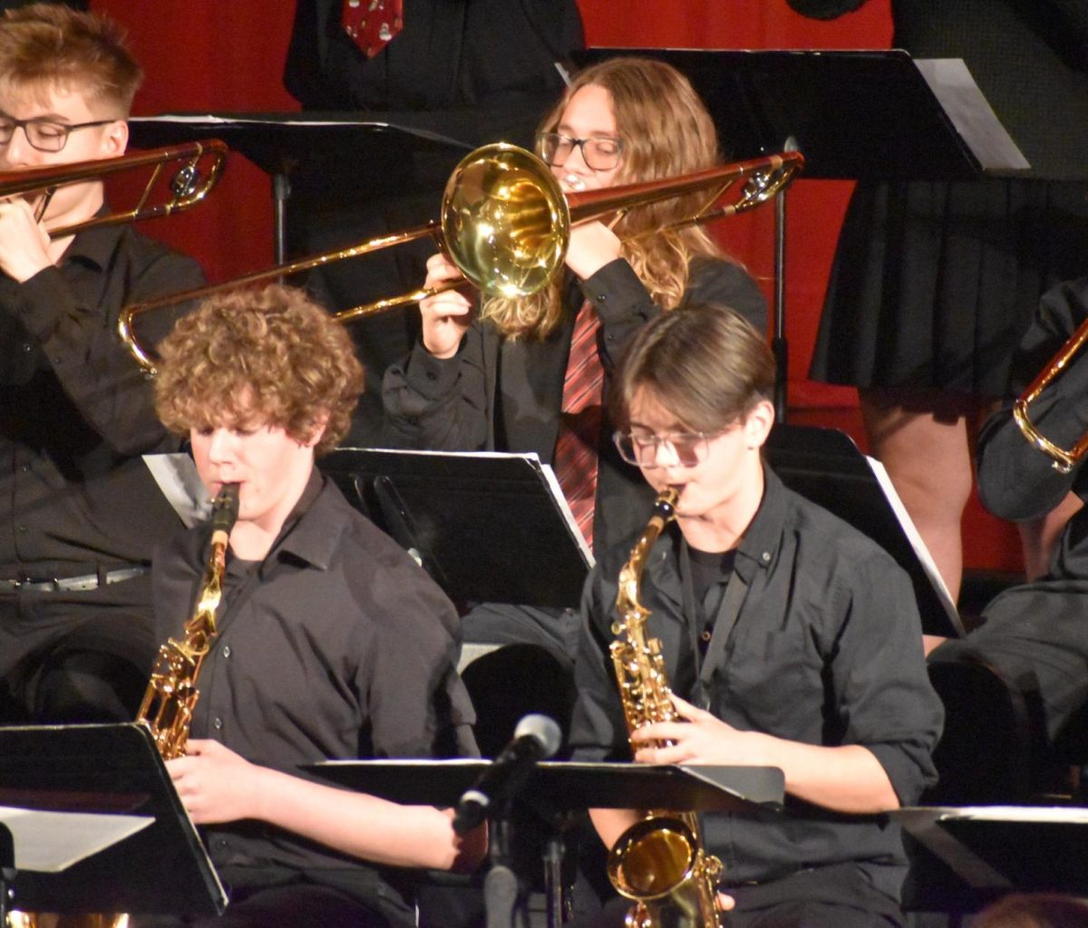 Junior Elliott Collie and Holland play their saxophones side by side. 