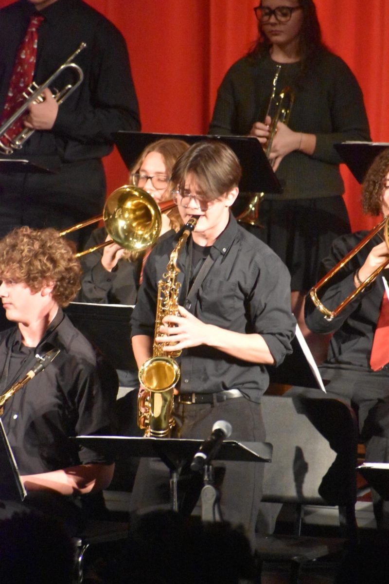 Junior Quintin Holland plays the saxophone during the jazz band's performance. Holland has been playing the alto saxophone since the 6th grade.