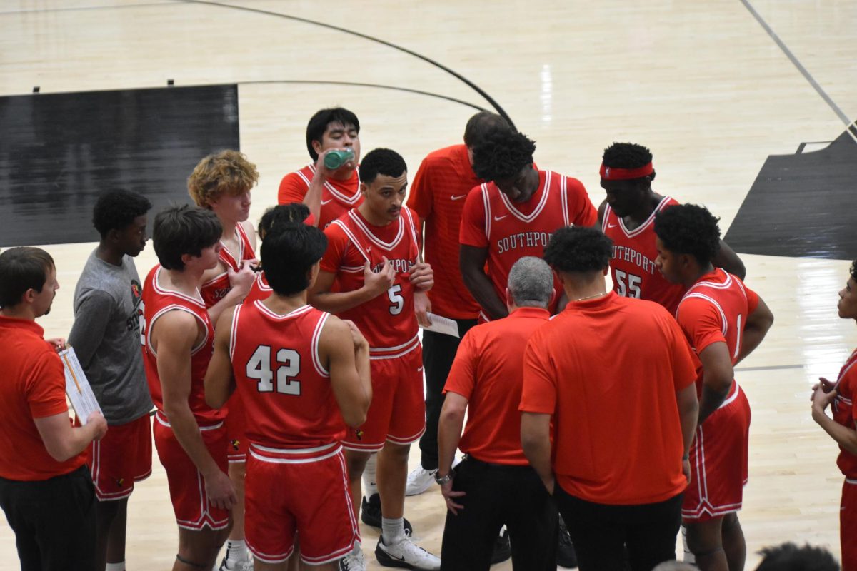 Head Coach Ben Phoades talks to his team during a timeout in the first quarter of their game against the Warriors at Warren Central High School.