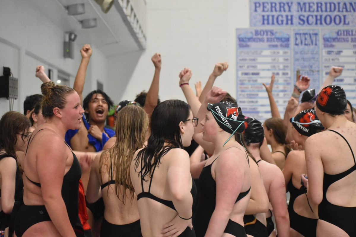 SHS swim teams meet together after the last event. The girls won the meet against Perry 94-78 while the boys lost 42-126.