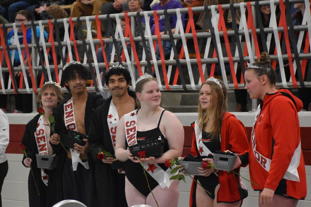 Seniors (left to right) Mathew Miers, Lal Mawi, Wali Ali, Kate Million, Hallie Kenyon and Faith Johnson line up and pose as they are announced for senior night. Their gift baskets were put together by 