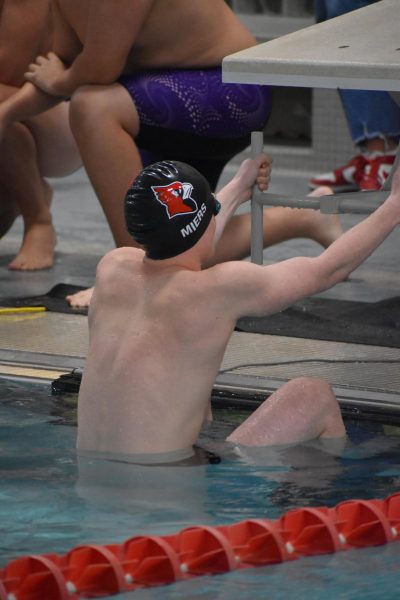 Senior Mathew Miers takes his mark preparing for his event. Miers was the first leg for 200-yard freestyle relay. 