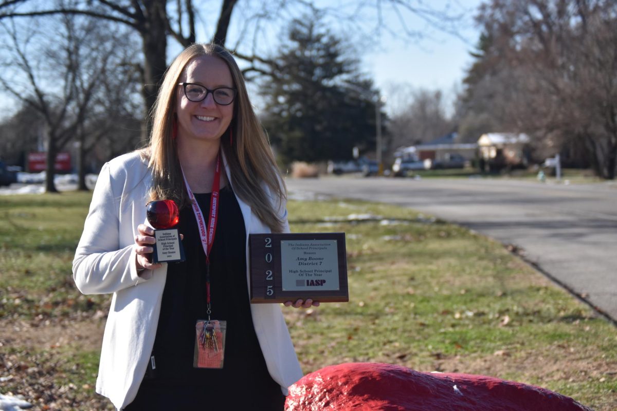 Principal Amy Boone poses in front of SHS alongside her Indiana State Principal of the Year awards. She has served as principal for three years, and before that, she worked as the Associate Principal of SHS