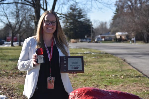 Principal Amy Boone poses in front of SHS alongside her Indiana State Principal of the Year awards. She has served as principal for three years, and before that, she worked as the Associate Principal of SHS
