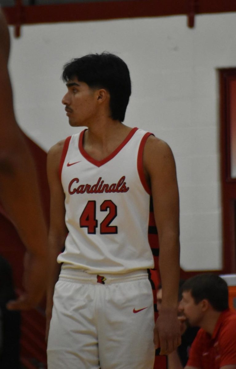 Senior Mathew Moreno stands beside the bench as he waits for the ball to cross half court. 