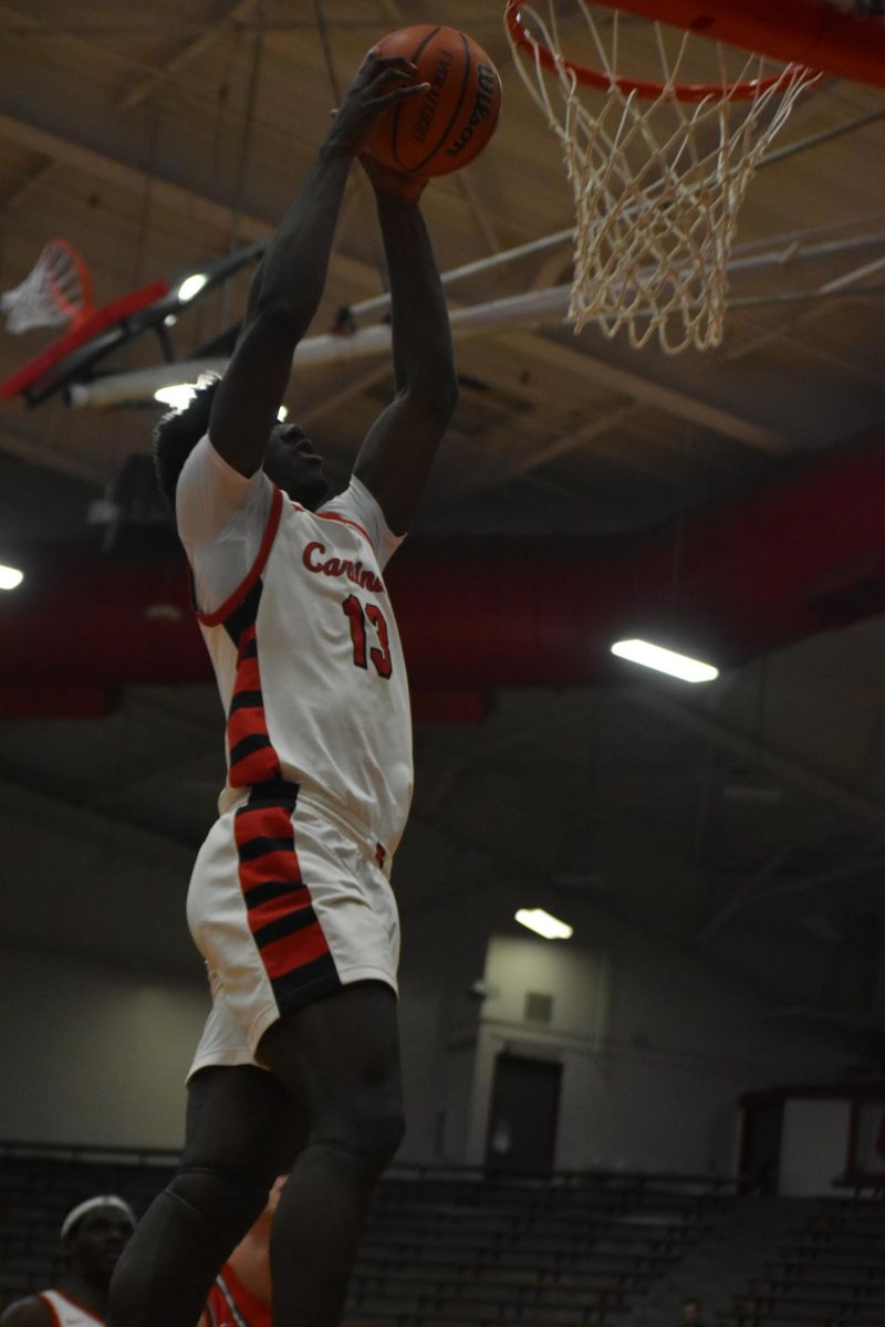 Senior Samuel Lloyd hammers the ball for a  dynamic dunk. Lloyd finished the night as the second leading scorer with 19 points.