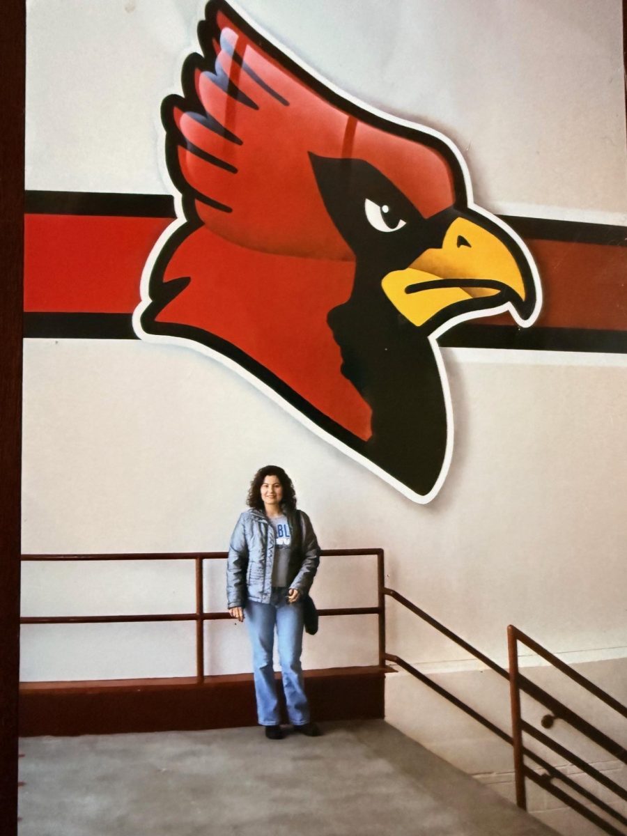 Former French teacher Carla Barker poses in front of the Cardinal in 2009.