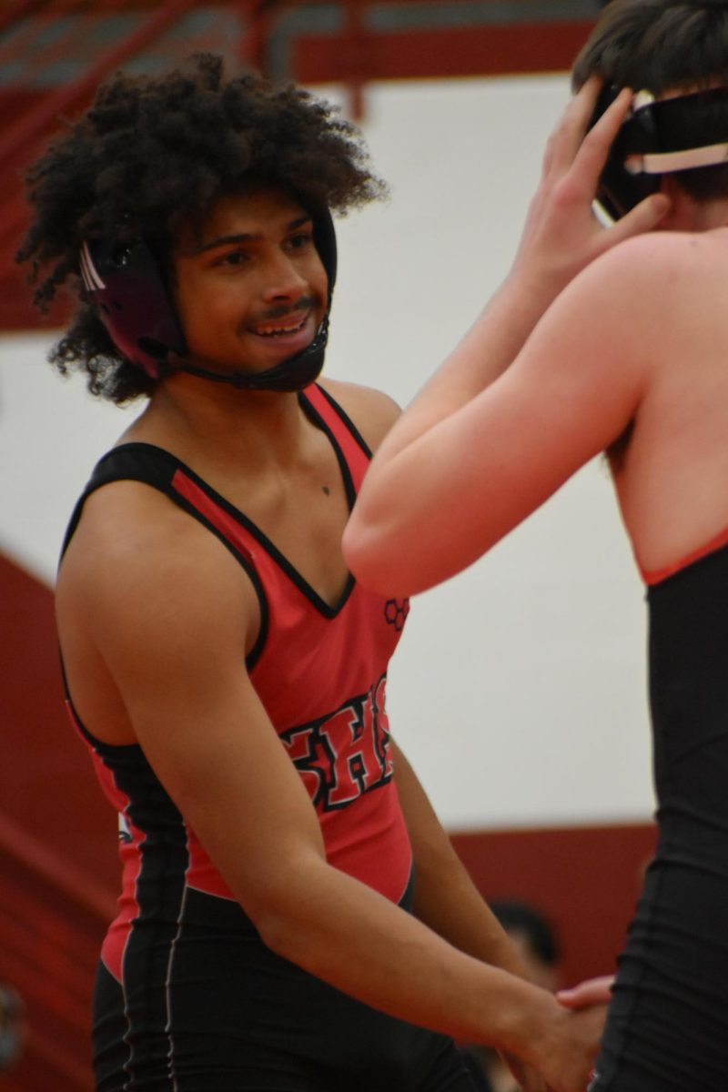 Junior Aiden Barton greets his opponent with a hand shake and smile during his JV meet. 
