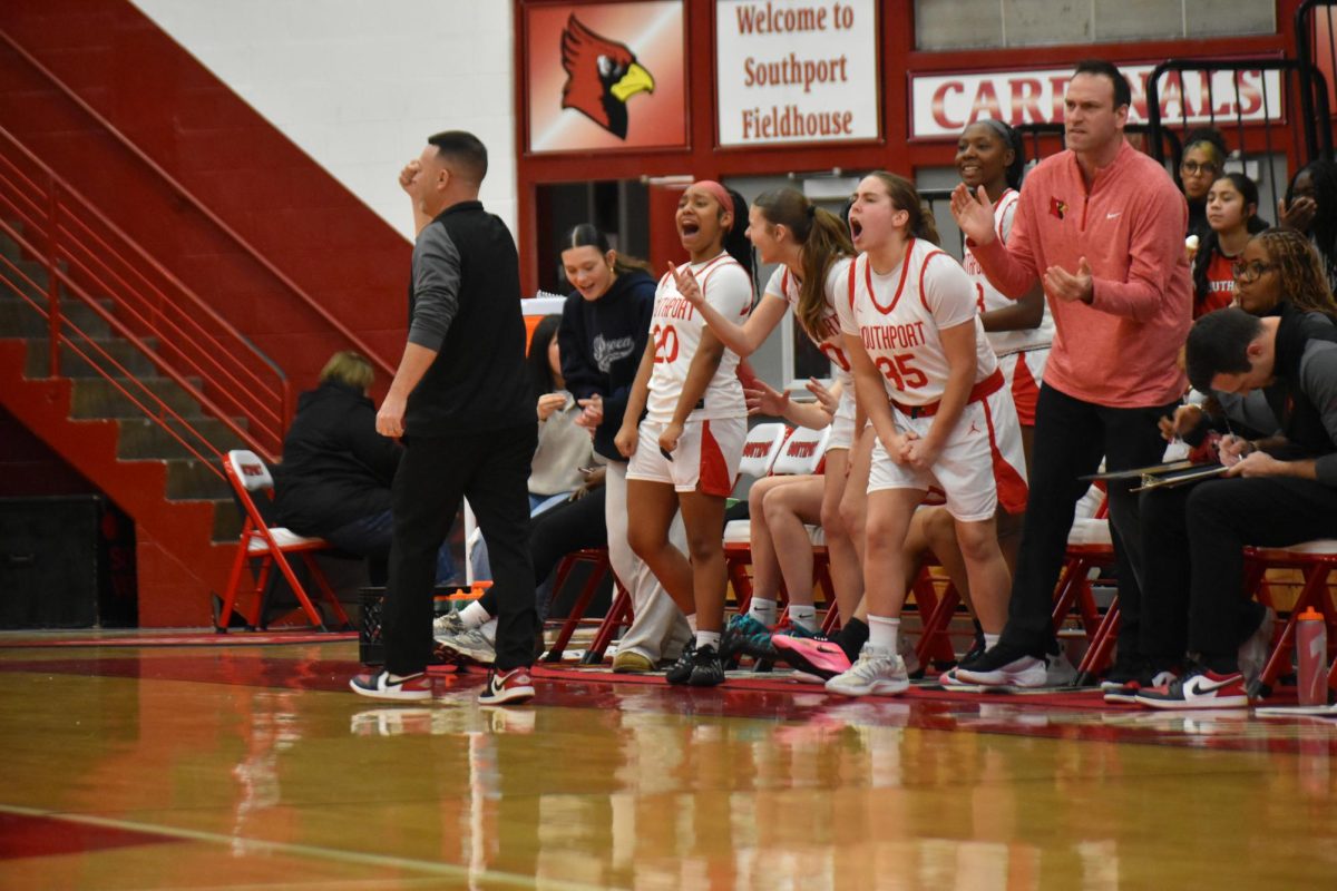The Lady Cards shout in excitement as they take pride in freshman Angie Martinez's 3-point basket. There were three consecutive 3-pointers shot in the first quarter.