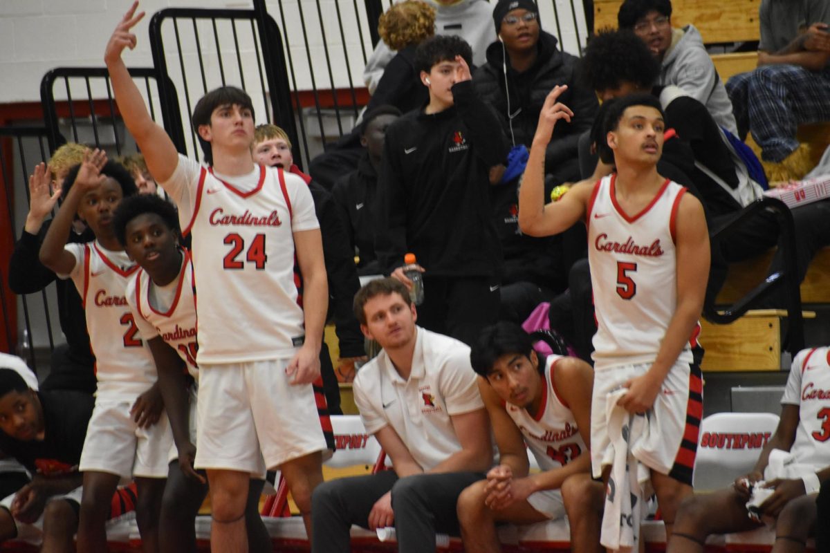 The Cards' bench raises their hands up, waiting to see if the three would drop. The Cards came into this game on a three-game losing streak, looking to snap their losses.