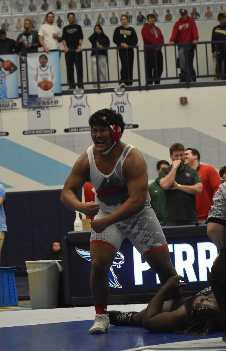 Sophomore Vanbawi Lian flexes and smiles after beating his opponent in the first round of regionals. Lian won his match 9-8, making him one of the two SHS wrestlers that will compete in semi-state.