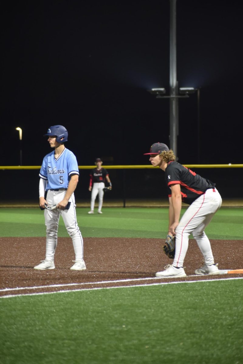 Junior Tristan Dudas holds the runner at first base, keeping him close to the bag. He watched the pitcher and waitied for a possible pickoff attempt. 