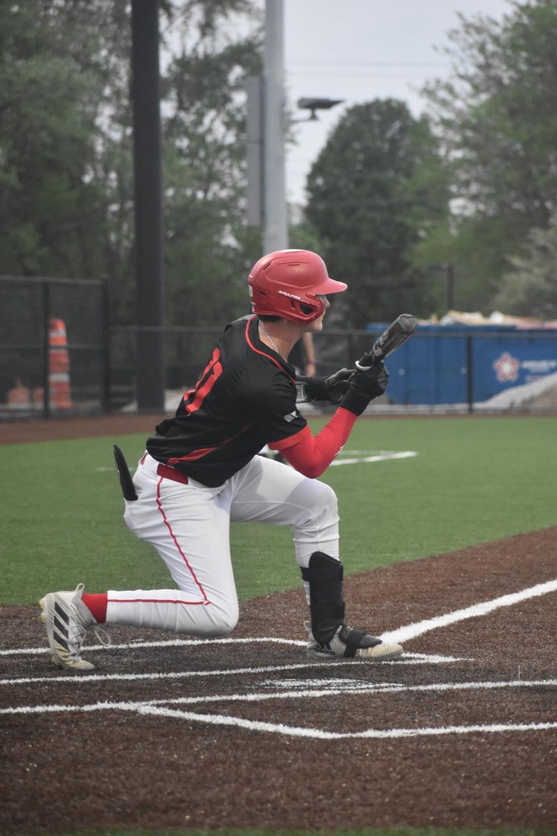 Junior Karrick Brooking squares to bunt, holding the barrel out while waiting for the pitch.