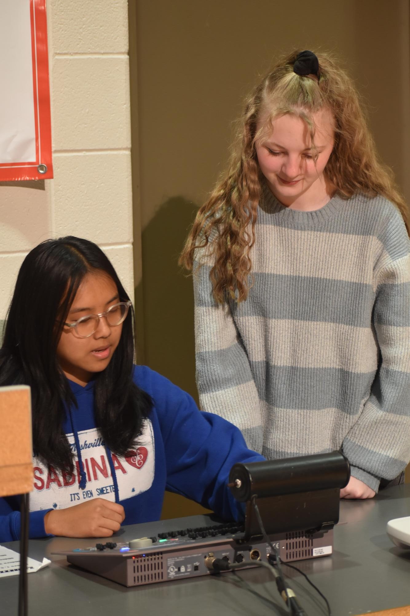 Senior Abbie Wethington teaches sophomore Mary Chanyaw how to use corner lights in The Black Box Theatre. This is one of the many things Chanyaw must learn.
