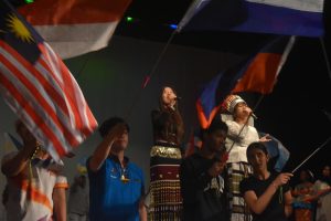 Junior Wesley Sailo and senior Zen Cing (left to right) sing "We are the world," during the closing act of the cultural showcase. Alongside them, 45 students filled the stage carrying various countries flags that represent all of SHS. At the end of the performance, Sailo said "Unity is a choice'." 