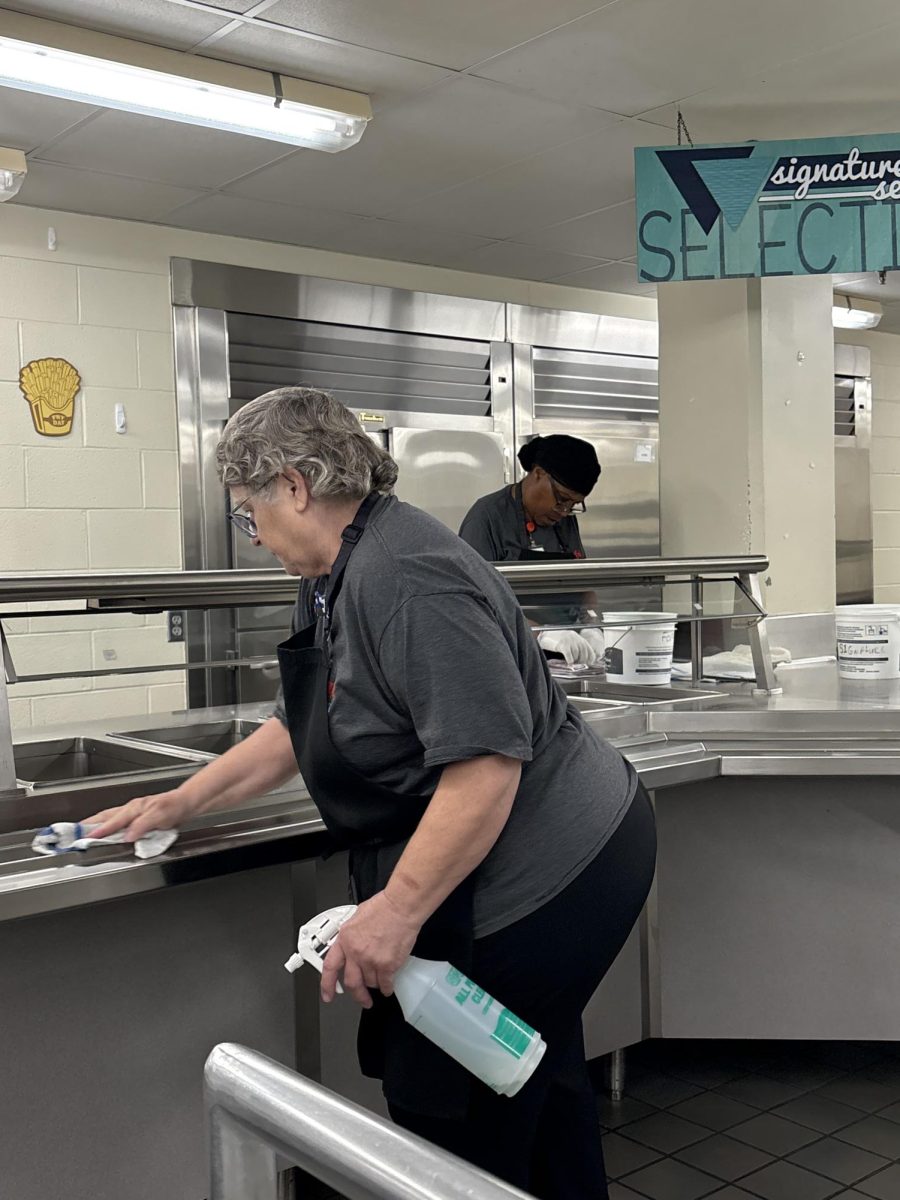 Lunch lady Connie Koleczek cleans the lunch line facilities during the school day at SHS. Cleaning tables is one of many tasks assigned to the lunch ladies.