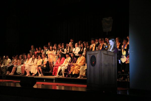 The 53 newly inducted juniors and seniors stand before blowing out their candles. The candles are the way of showing they have been inducted. 