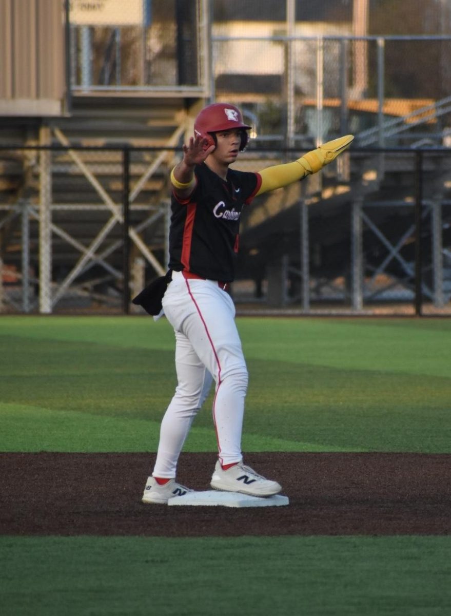 Senior Riley Matlock signals safe after stealing second. Matlock had three stolen bases and three at bats.