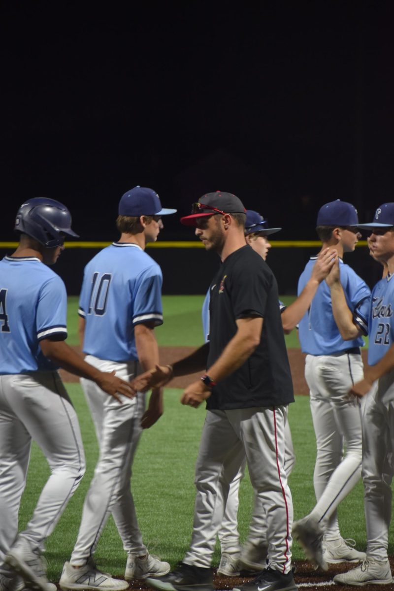 Head coach Brendan Dudas shakes the Perry baseball player's hand after the game. Dudas attended Perry Meridian high school.