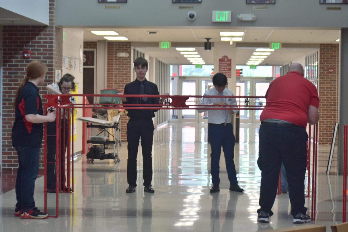 The students who arrived early help Science and Engineering teacher Anthony Stanich set up the robotics trust. They usually take the robotics trust to competitions to hang their inventions on.
