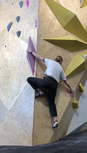 Science teacher Olivia Brown rock climbs at her local gym, North Mass Boulder. She has been instructing rock climbing for five years. (photo contributed by Brown)