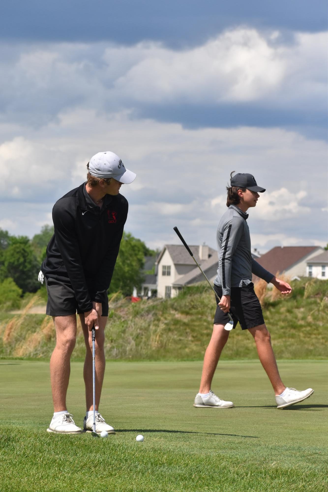 Senior Tyler Pierle (left) and freshman Conner Seligman (right) warm up before their match against Greenwood on April 29. Pierle shot one-over 35, and Seligman shot 42.
